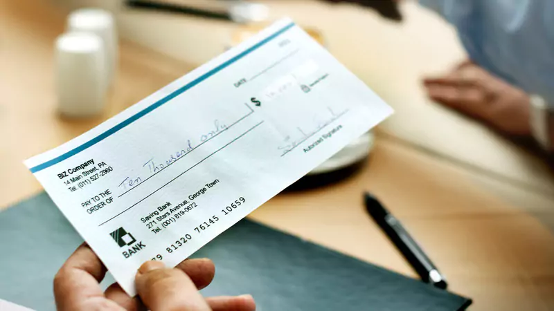 close-up-of-paycheck-being-handed-over-symbolizing-nurse-salary-and-income-considerations